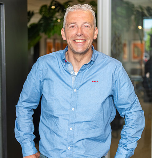 Rob Slieker met handen in zijn zijde bij deuropening